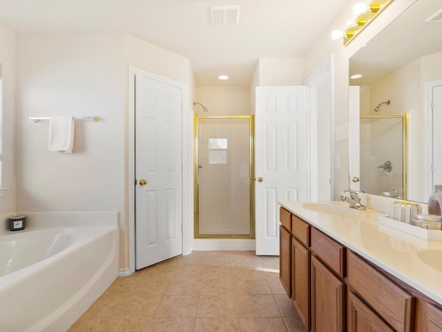 full bathroom featuring visible vents, a shower stall, a garden tub, tile patterned floors, and a sink