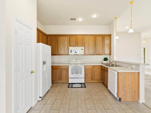 kitchen featuring visible vents, a sink, white appliances, a peninsula, and light floors