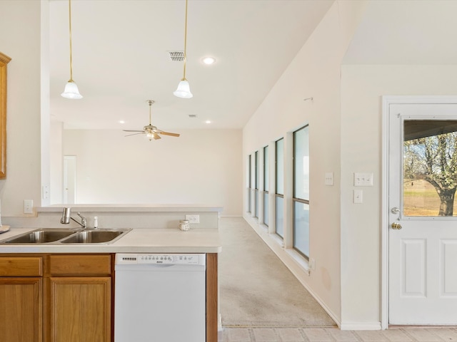 kitchen featuring a ceiling fan, visible vents, a peninsula, white dishwasher, and a sink