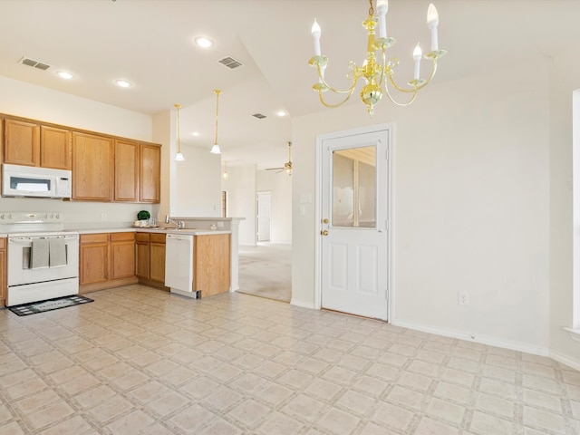 kitchen featuring visible vents, white appliances, a peninsula, and light countertops