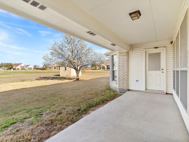 view of patio / terrace with visible vents and a residential view