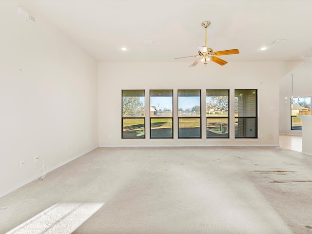 spare room with recessed lighting, light carpet, and plenty of natural light