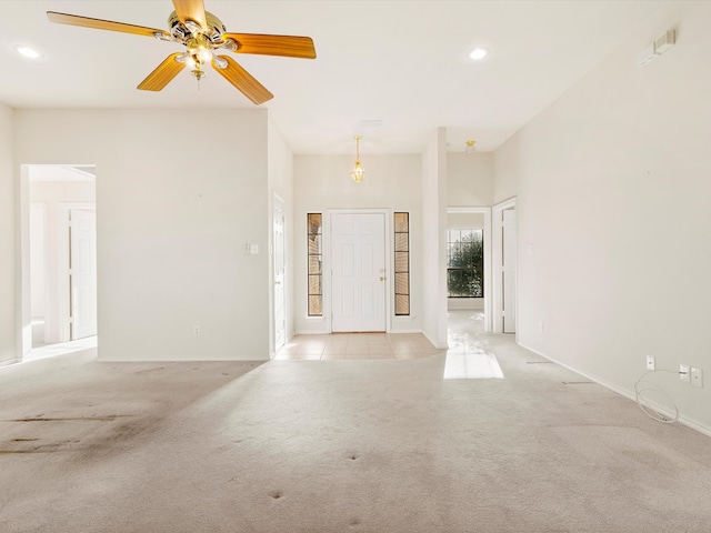 entryway with light tile patterned floors, recessed lighting, light colored carpet, and a ceiling fan