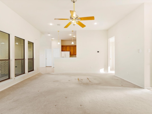 unfurnished living room featuring visible vents, baseboards, ceiling fan, light carpet, and recessed lighting