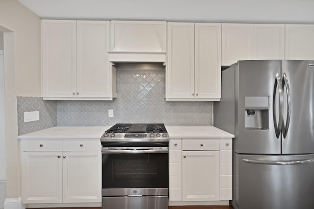 kitchen featuring stainless steel appliances, custom exhaust hood, decorative backsplash, and white cabinetry