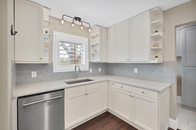 kitchen with open shelves, tasteful backsplash, stainless steel dishwasher, and a sink