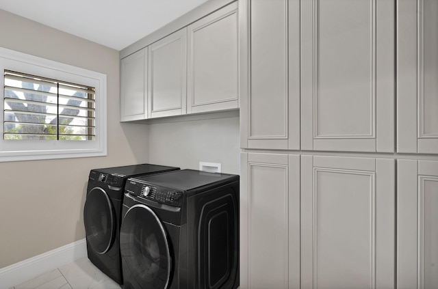 laundry area featuring baseboards, cabinet space, and independent washer and dryer