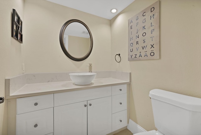 bathroom featuring toilet and vanity