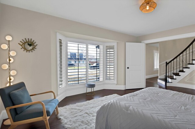 bedroom with wood finished floors and baseboards