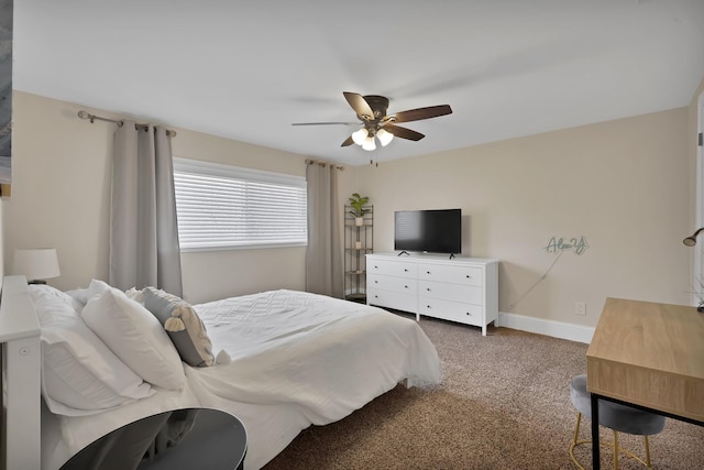 bedroom featuring dark colored carpet, baseboards, and a ceiling fan