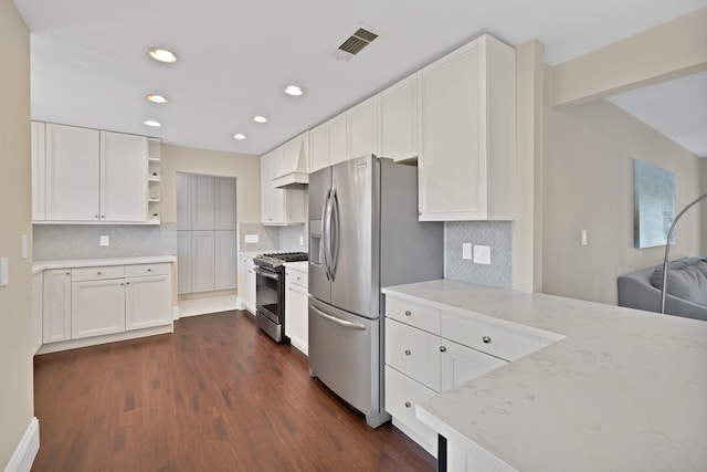 kitchen with open shelves, visible vents, light stone counters, and appliances with stainless steel finishes