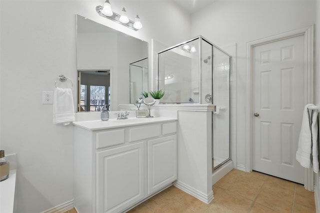 full bathroom with tile patterned floors, a stall shower, and vanity