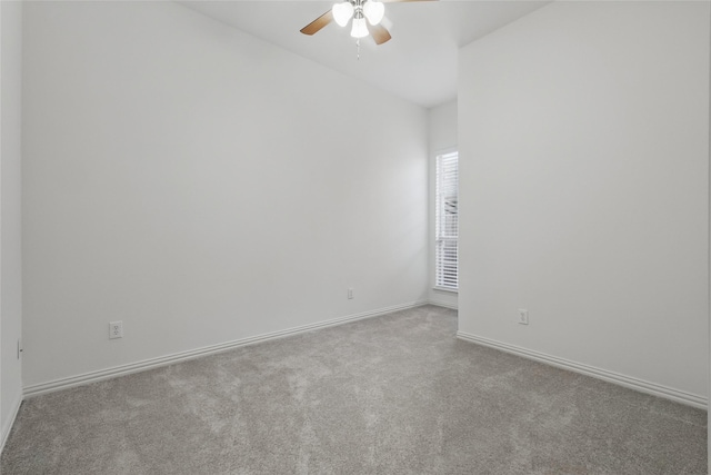 spare room featuring baseboards, carpet floors, and ceiling fan