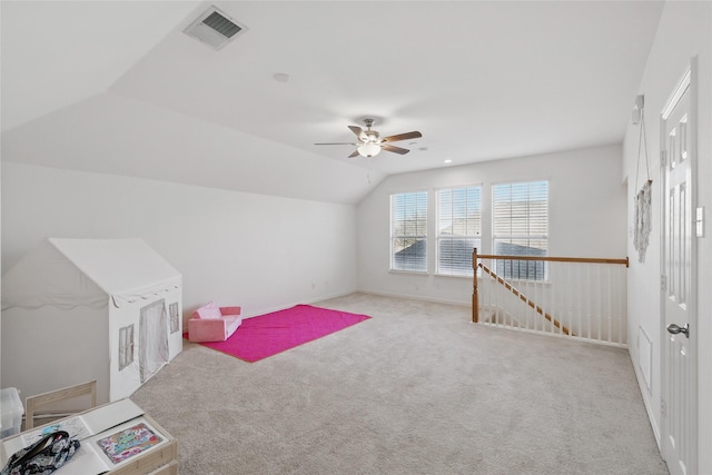 rec room with a ceiling fan, vaulted ceiling, carpet, and visible vents