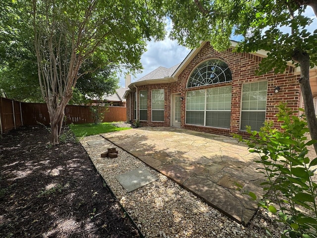 1161 Mission Ln, Lantana, TX 76226 - back of house featuring brick siding, a fenced backyard, and a patio