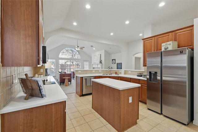 1161 Mission Ln, Lantana, TX 76226 - kitchen with stainless steel appliances, a peninsula, a sink, a ceiling fan, and light countertops