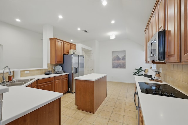 kitchen featuring visible vents, a center island, light tile patterned flooring, stainless steel appliances, and a sink