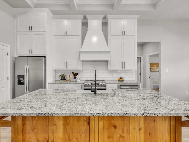 kitchen featuring a spacious island, tasteful backsplash, premium range hood, and stainless steel appliances