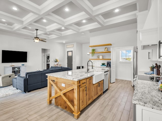 kitchen featuring open shelves, beamed ceiling, appliances with stainless steel finishes, and a sink