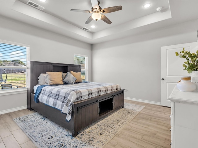 bedroom with visible vents and a raised ceiling