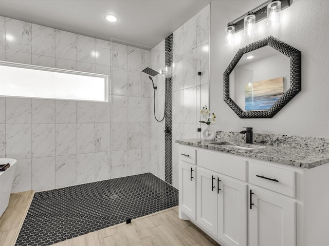 bathroom with vanity, recessed lighting, wood finished floors, and walk in shower