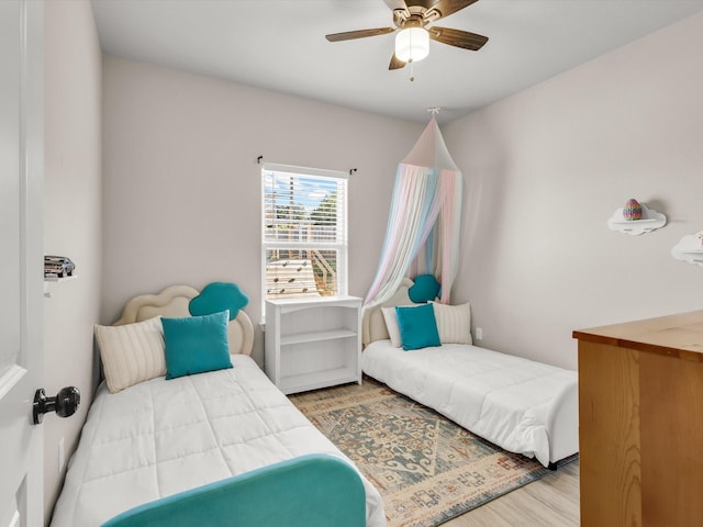 bedroom featuring wood finished floors and ceiling fan