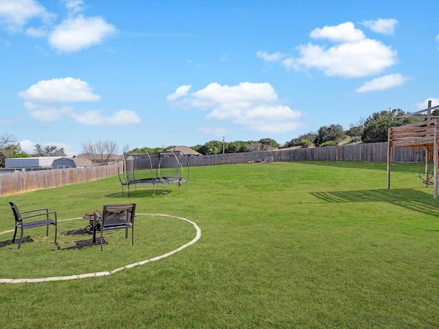 view of yard featuring a fenced backyard and a trampoline