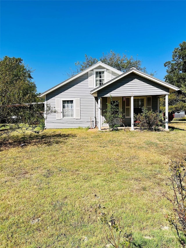 view of front of house with covered porch and a front yard