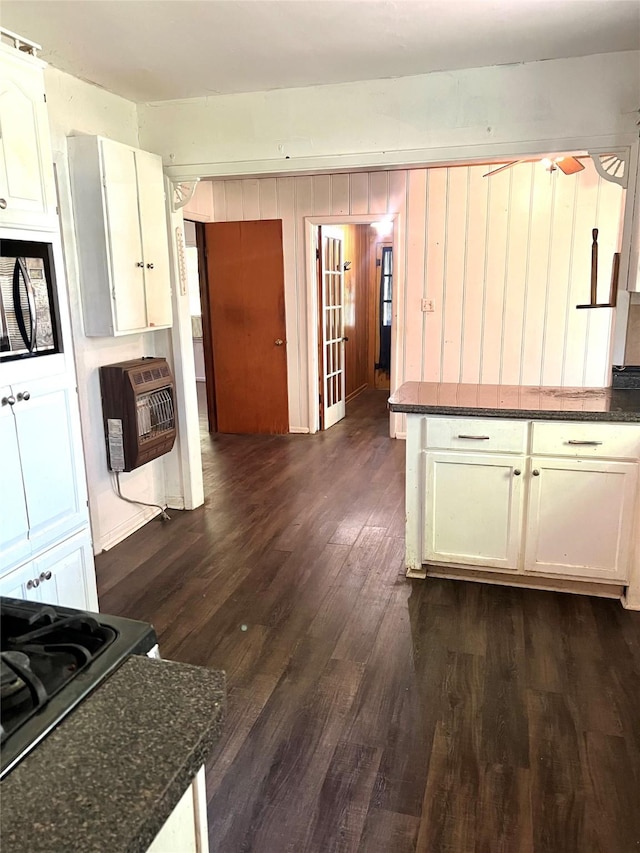 7155 Farm Rd Unit 1499, Sumner, TX 75486 - kitchen with white cabinetry, range with gas stovetop, ceiling fan, and dark wood-type flooring