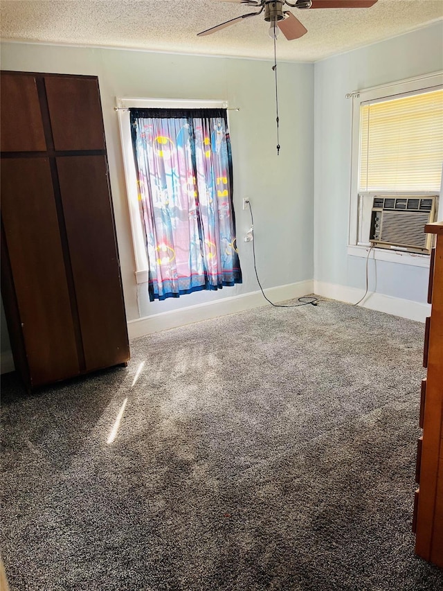 unfurnished bedroom with carpet floors, a textured ceiling, and a ceiling fan