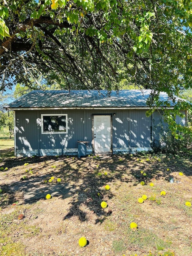 exterior space with an outbuilding and metal roof