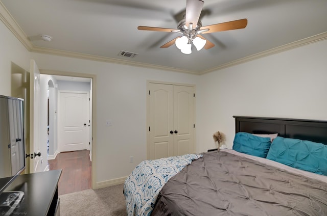 bedroom with visible vents, baseboards, a closet, and ornamental molding