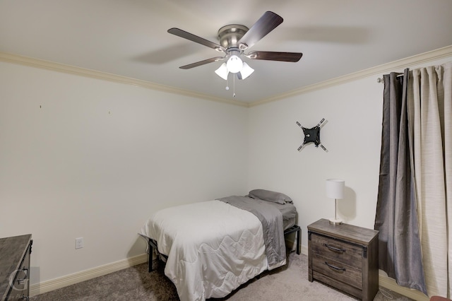 bedroom featuring ceiling fan, baseboards, carpet floors, and ornamental molding