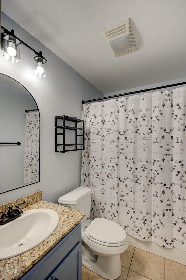 bathroom featuring vanity, tile patterned floors, toilet, and visible vents