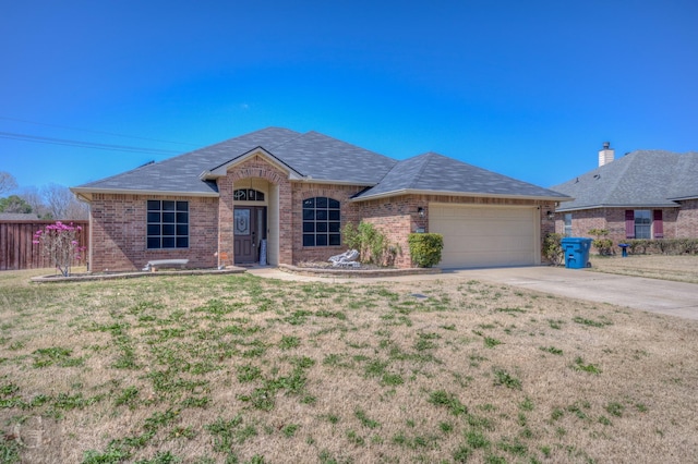 ranch-style house featuring brick siding, an attached garage, driveway, and a front lawn