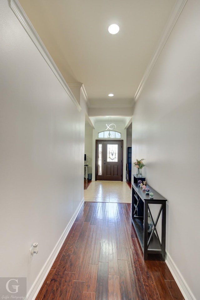 doorway to outside featuring crown molding, recessed lighting, wood finished floors, and baseboards