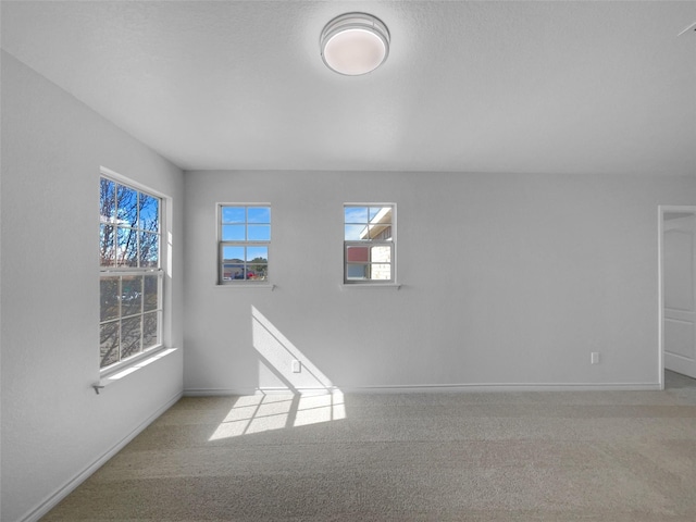 empty room with carpet flooring and baseboards