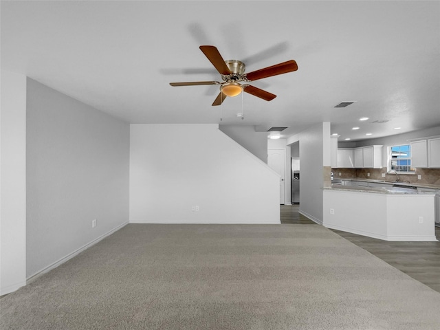 unfurnished living room with visible vents, recessed lighting, a ceiling fan, and baseboards