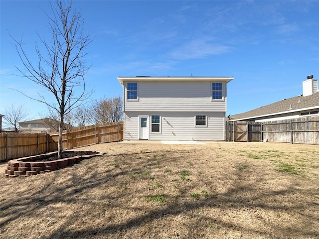 rear view of property with a lawn and a fenced backyard