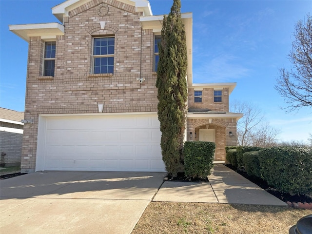 view of front of house with concrete driveway, an attached garage, and brick siding