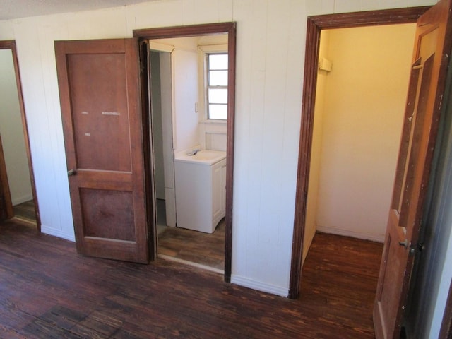 interior space with a sink, baseboards, and dark wood-style flooring