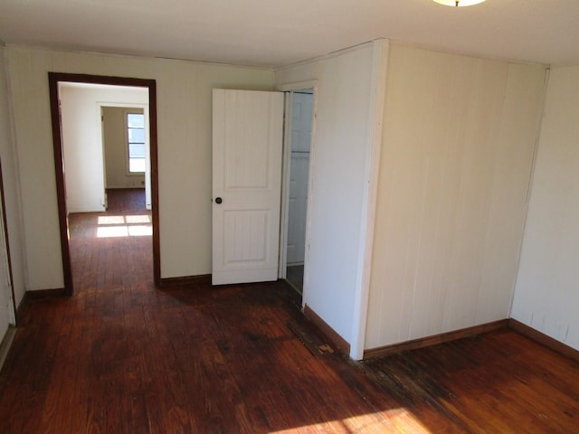 interior space featuring dark wood-type flooring and baseboards