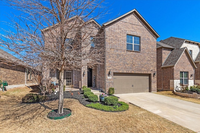 traditional home with a front yard, brick siding, an attached garage, and driveway