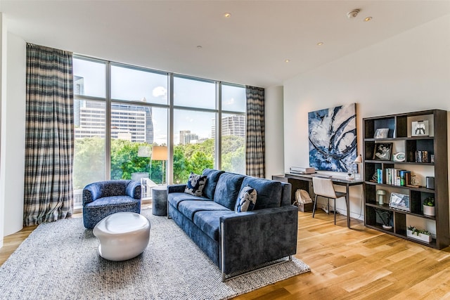 living area featuring expansive windows, a view of city, and wood finished floors