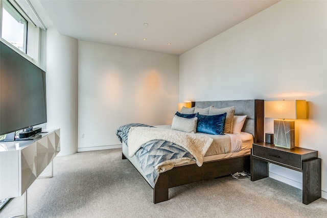 bedroom featuring light colored carpet