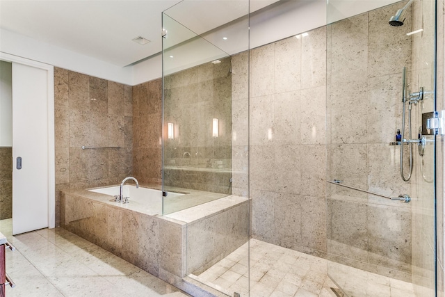 bathroom featuring a bath, a walk in shower, and tile walls