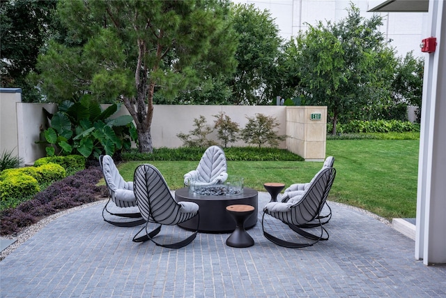 view of patio / terrace with a fire pit and fence