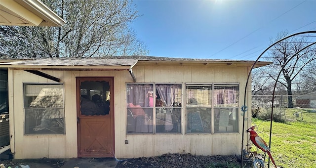 view of outbuilding featuring fence