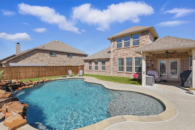 view of pool with a patio, fence private yard, a fenced in pool, and french doors