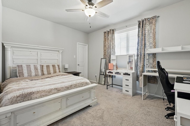 bedroom featuring a ceiling fan, light colored carpet, and baseboards